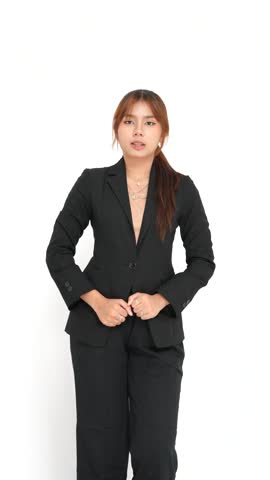 Happy young woman in stylish black suit posing with peace sign gesture against white background