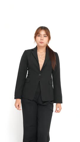 Young woman in a black professional blazer suit making a playful peace sign gesture on a white