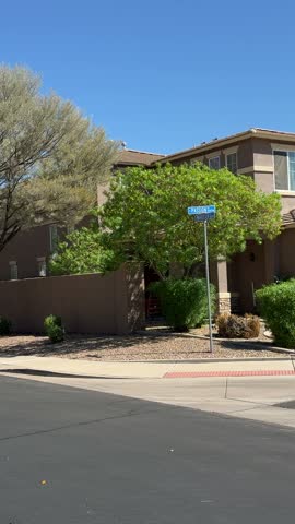 Suburban neighborhood street corner with stucco houses, vertical
