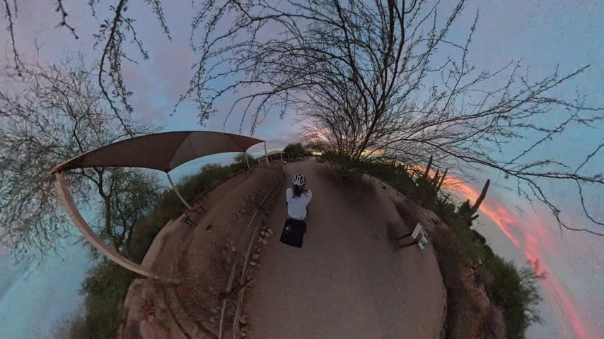 Cyclist Riding on Park Trail at Sunset 360 View