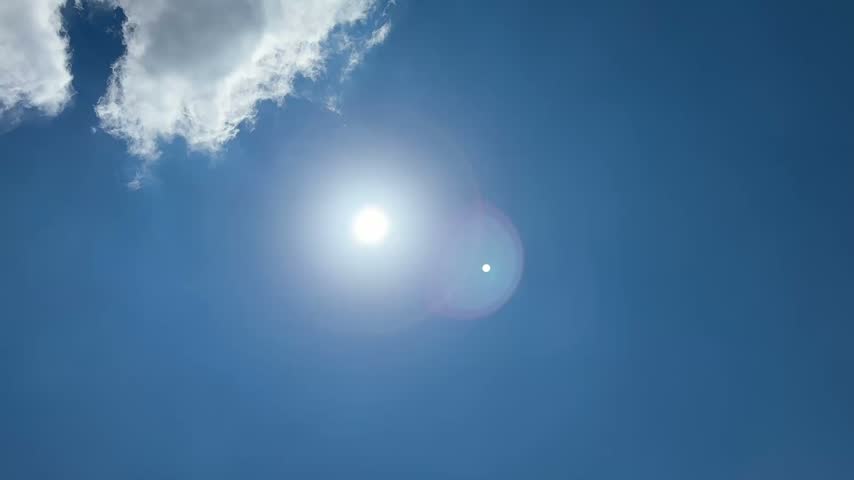 Blue Sky with Puffy Clouds on Hot Minnesota Summer Day, and Bird Flying Across