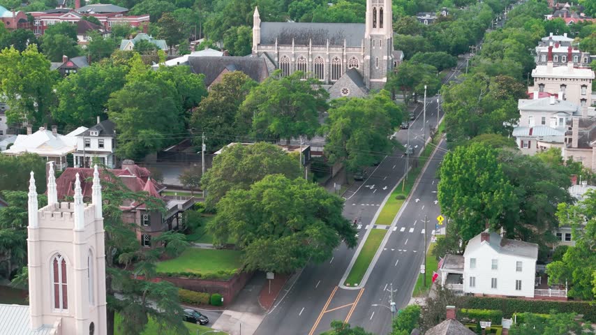 Aerial view of South 3rd Street featuring a historic church, lush green trees, and residential houses in Wilmington, North Carolina, United States.