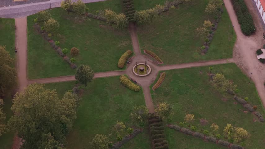 Aerial view of a park with a central fountain, symmetrical pathways, and manicured hedges in Olomouc, Olomouc Region, Czechia.