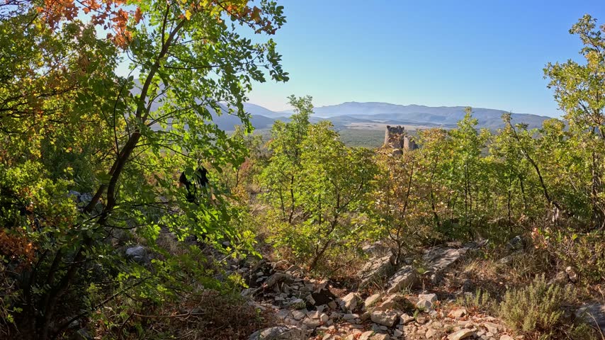 Mature hiker climbing the mountain near old fort in Croatia