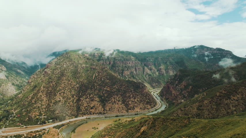 Interstate highway and river winding through a canyon aerial
