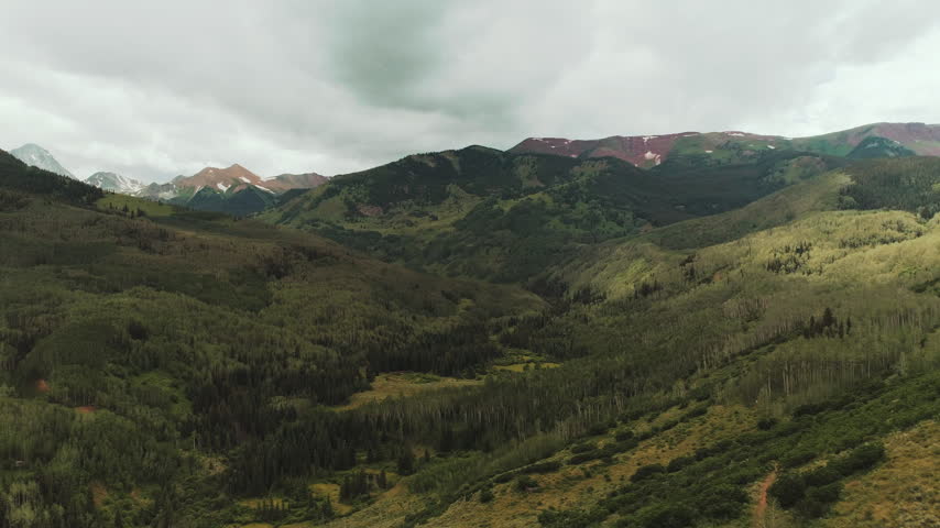 Green mountain valley of aspen and pine in Colorado aerial