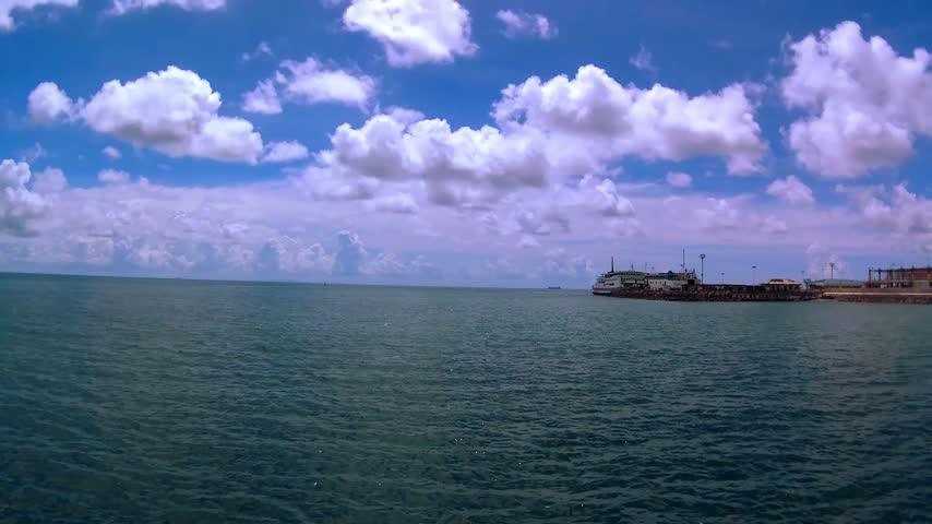 Sea, port, ferry, tanker. Cloudy.