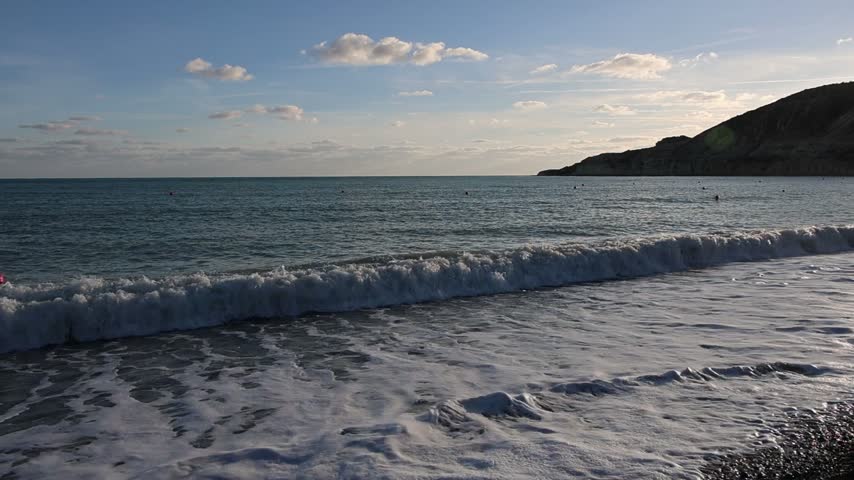 Autumn in Mediterranean pebble beach at sunset in Pissouri, Cyprus