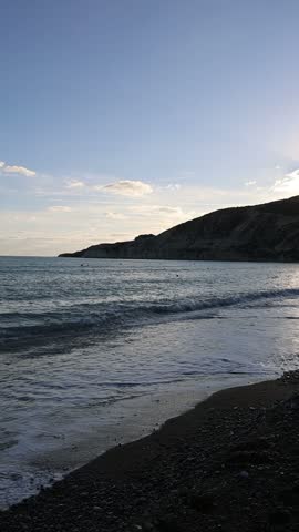 Autumn in Mediterranean pebble beach at sunset in Pissouri, Cyprus