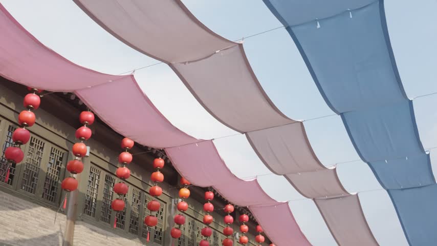 Chinese Architecture with Red Lantern Decoration Beneath Colorful Fabric Canopy, Festive Cultural Temple Courtyard, Traditional Building Facade, Joyful China Travel Photography and Tourism Scene