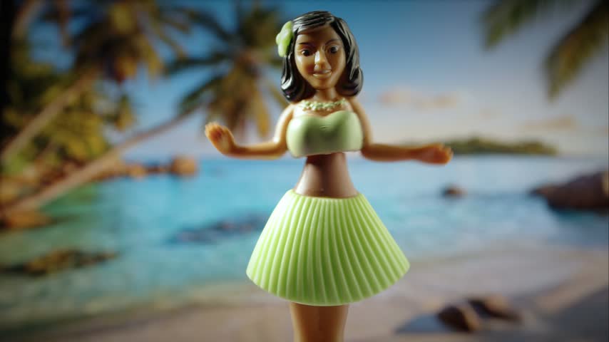 Close-up of a Hawaiian hula dancer doll against a beautiful tropical beach background with palm trees and turquoise ocean water