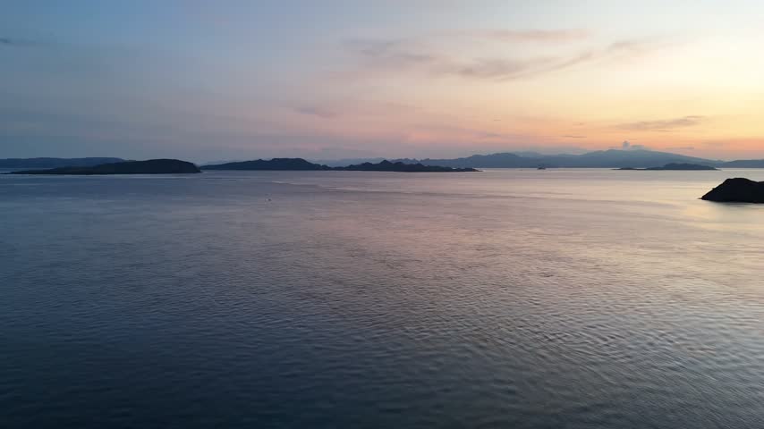 Aerial view of islands in the ocean at sunset