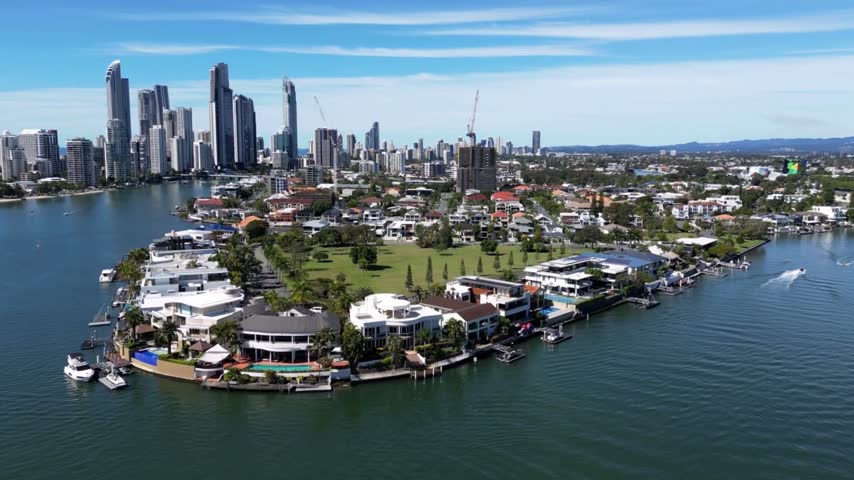 Aerial View of Surfers Paradise, Gold Coast, Australia, Featuring Waterfront Homes, Scenic Canals, and Chevron Island in the Foreground, Showcasing the City’s Iconic Skyline and Coastal Urban Landscape.