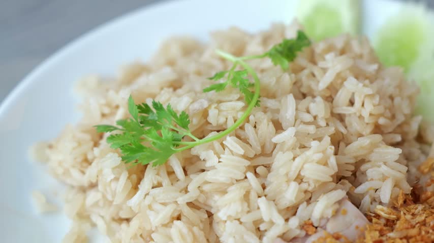 Steamed Chicken Rice with Crispy Fried Garlic, Cucumber, Cilantro, and Brown Rice