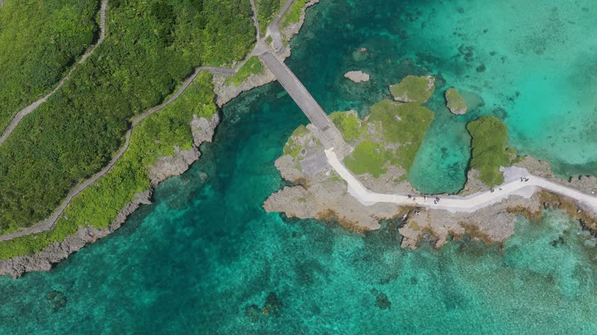 Imgya Marine Garden on Miyakojima, Okinawa, Japan, features a coastal bridge crossing sheltered turquoise waters surrounded by rocky shores and subtropical island scenery near Shigira