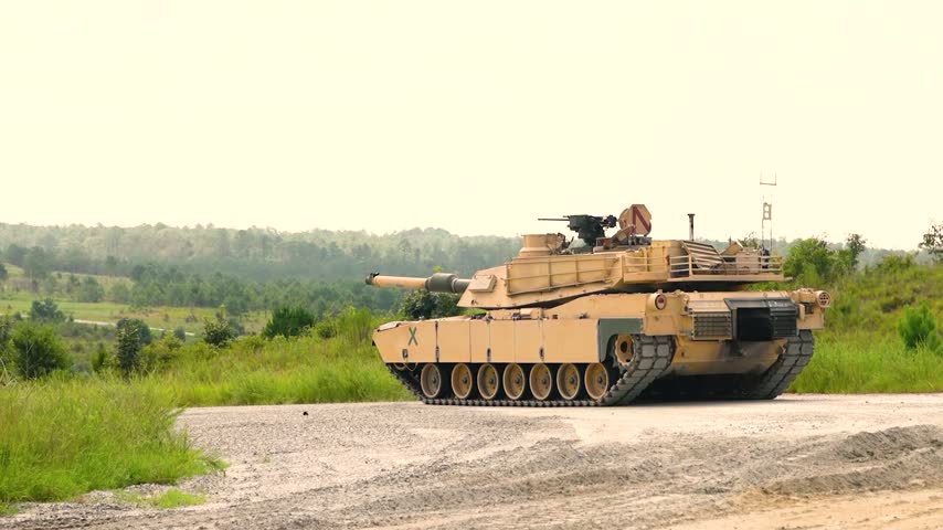 Military Battle Tank Firing Main Gun Cannon Producing Large Fireball Flash During Live Exercises.