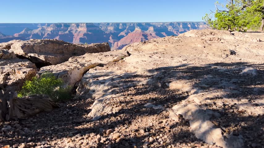 Grand Canyon rim overlook with rocky foreground in Arizona, United States