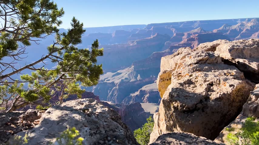 Grand Canyon rim overlook with rocky foreground in Arizona, United States