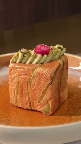 Pistachio Cream Cube Croissant Topped with Raspberry on Ceramic Plate