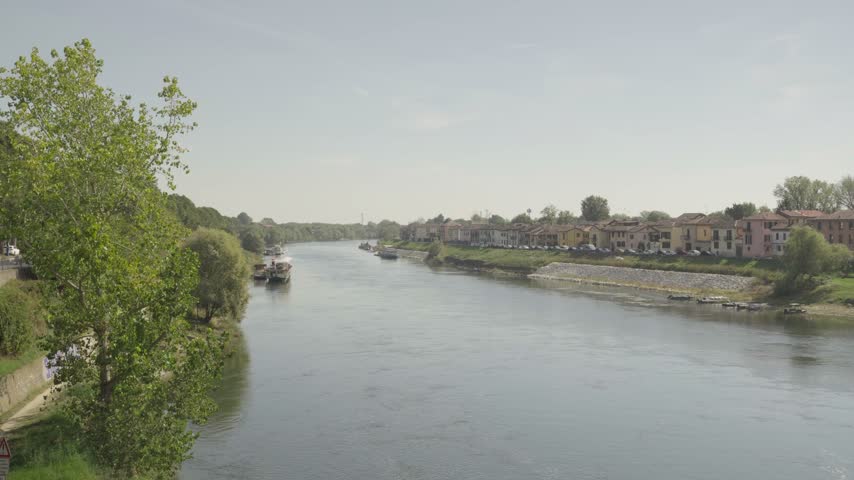Scenic view of the Ticino River and surrounding urban landscape in Pavia, Lombardy, Italy.