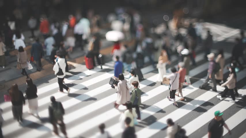 People Crossing a Busy Urban Crosswalk in Osaka Japan