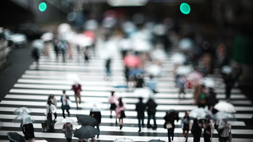 Crowd Crossing a Crosswalk on a Rainy Day in Osaka