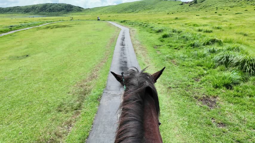 Riding a horse along the scenic trail in Kusasenri, Mount Aso.