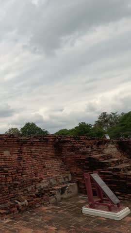 Panning shot reveals historic brick ruins and towers of Wat Chaiwatthanaram in Ayutthaya, Thailand.