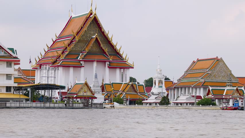 Telephoto shot of Wat Kalayanamit Buddhist temple along Chao Phraya River in Bangkok, Thailand.