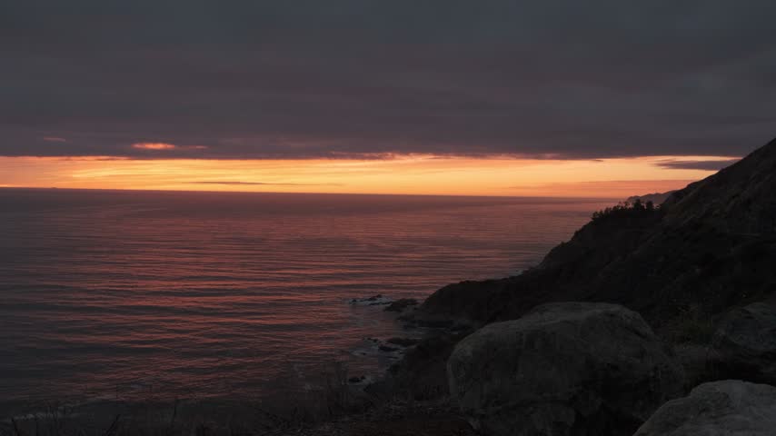 Sunset Reflecting Over Ocean and Coastal Cliffs - Big Sur, California
