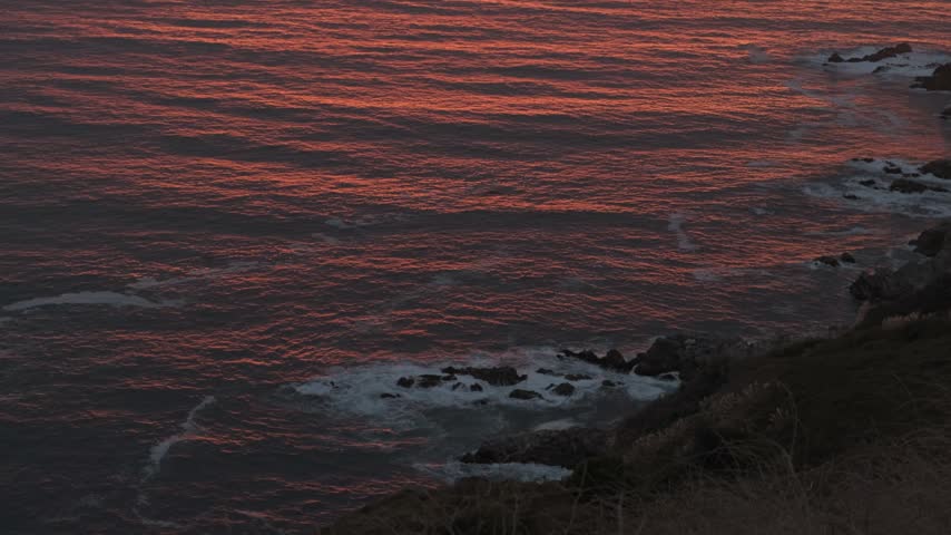 Intense Sunset Light Reflecting on Rocky Coastline - Big Sur, California
