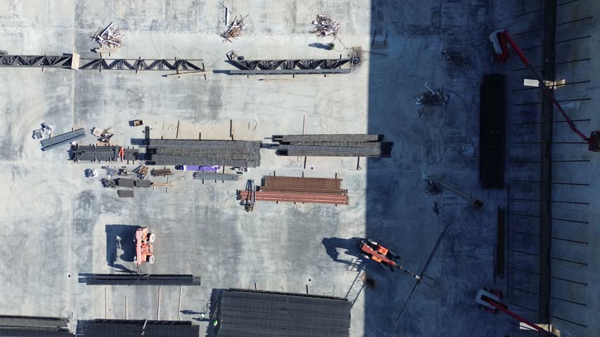Building expansion adjacent to South shows active development phases along Lewisville. Foundation work, utility trenches, heavy machinery, Texas district location, Lewisville, Texas. USA.