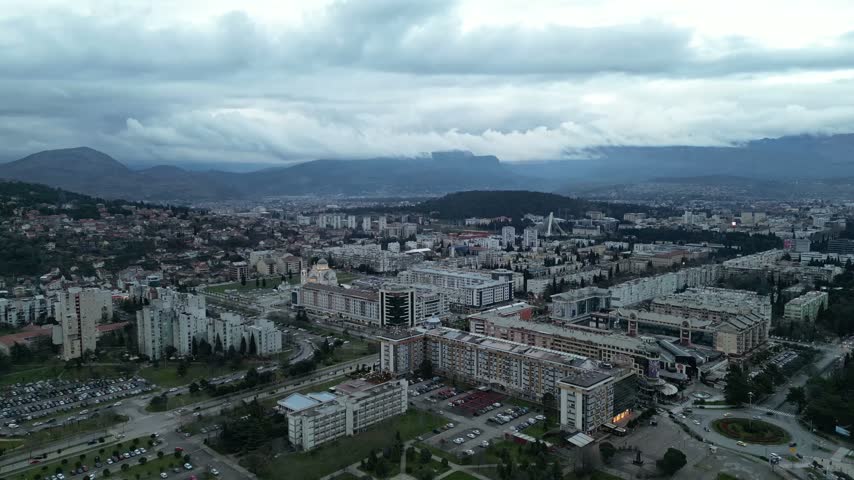 Wide aerial view of Podgorica city skyline with Cathedral of the Resurrection of Christ, Preko Morace district and mountains in Montenegro