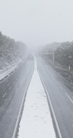 Vertical slow motion snow covered road in town. Vertical slow motion shot of a snow covered road in a quiet town in Chigasaki Japan