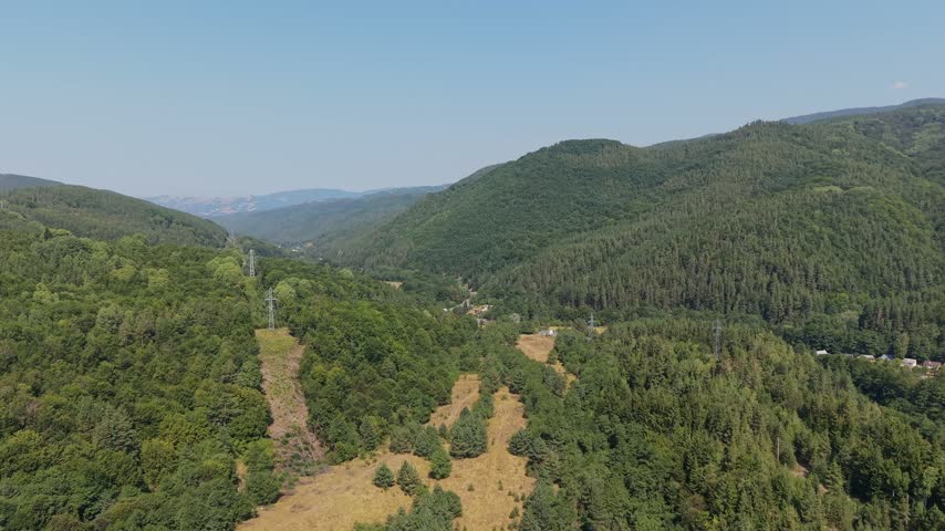 Travel destination aerial view showing mountain pass roads and remote settlements near Predela, Bulgaria.