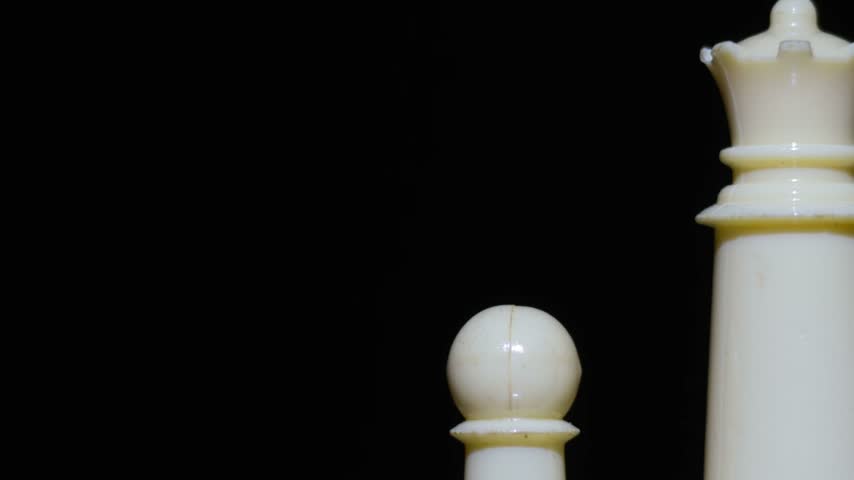 Queen and pawn chess pieces on the board.