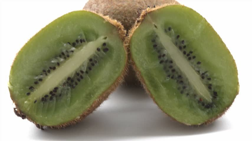 Cut kiwi fruit shown in extreme 4K macro with vivid green flesh and a pattern of black seeds.
