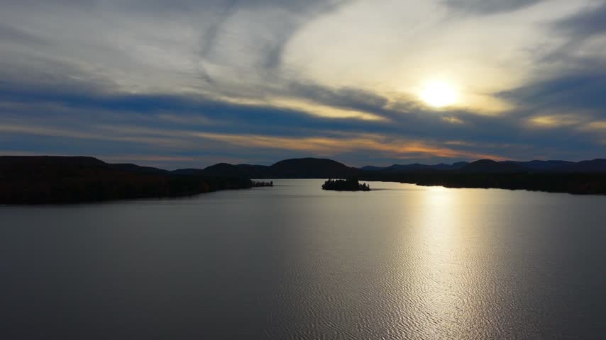Light reflecting on a lake at dusk, atmospheric nature aerial shot.