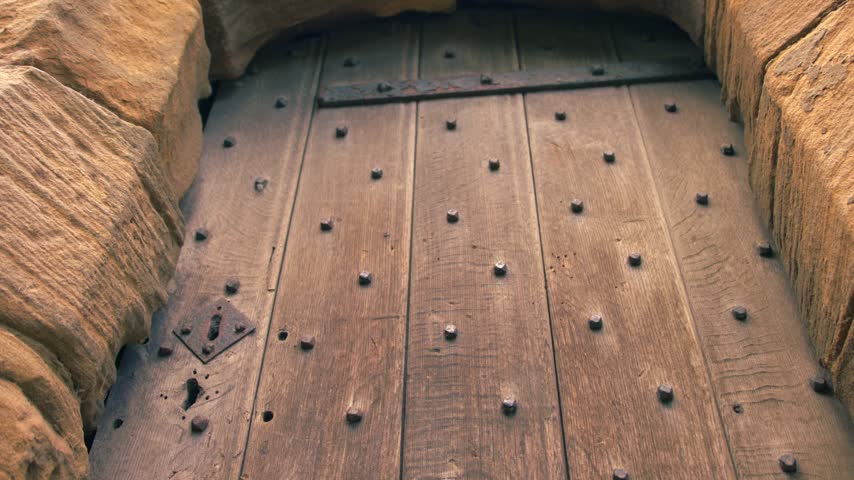 Old Medieval building wooden door medium tilting 4k shot selective focus