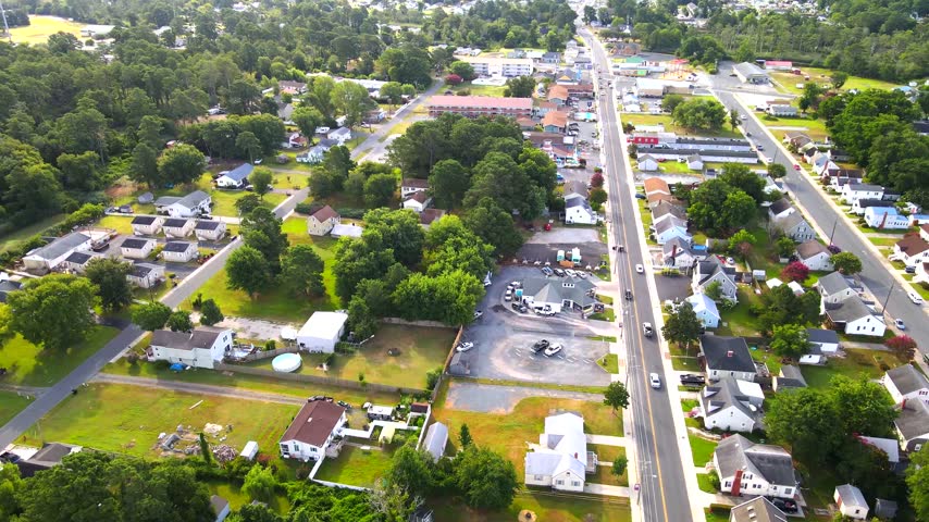 An aerial turn reveals parallel streets and detached homes across Chincoteague, Virginia.
