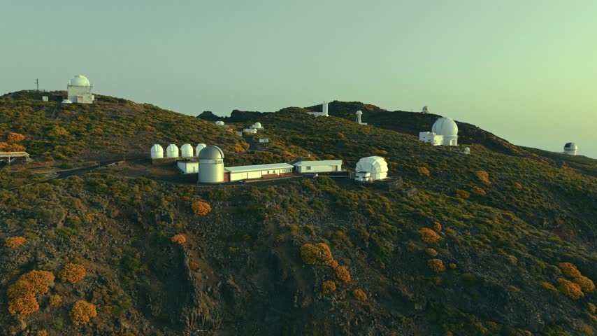 Aerial view of Roque de los Muchachos Observatory telescopes on mountain ridge, La Palma, Canary Islands