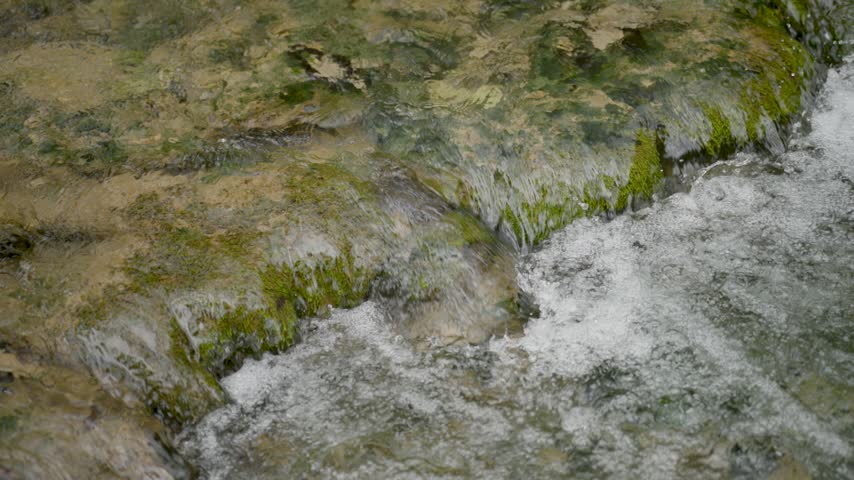 Beautiful waterfalls close-up shot on forest stream. Slow motion.