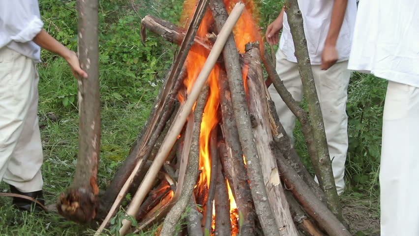 Men building campfire