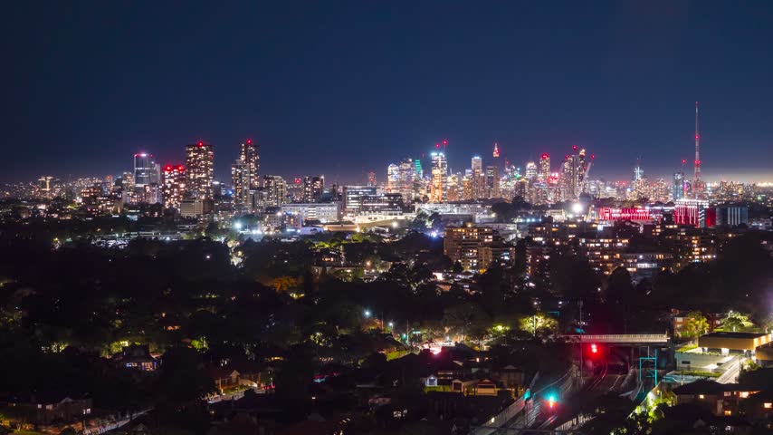 Night time wide shot time-lapse of Sydney City viewed from the Northern Suburbs, New South Wales