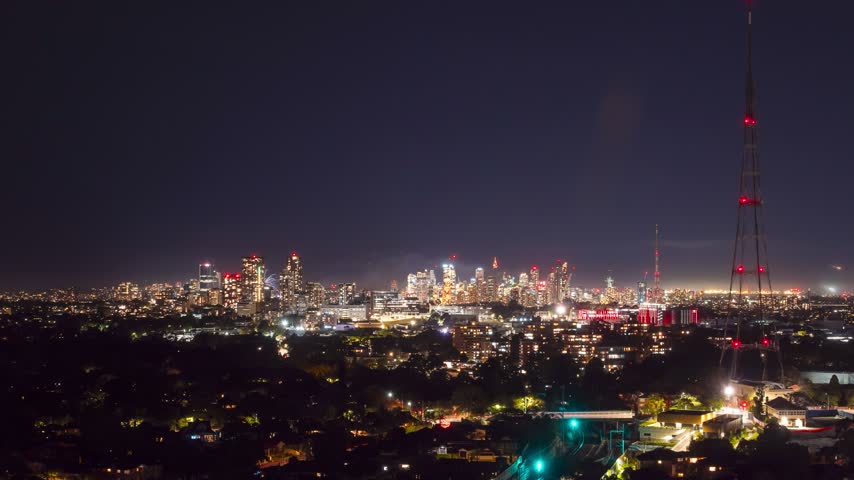 Night time wide shot time-lapse of Sydney City viewed from the Northern Suburbs, New South Wales