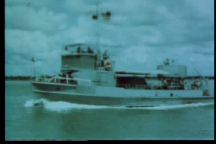 1960s - A crew of minesweepers comes under fire while clearing the Saigon River of mines during the Vietnam War