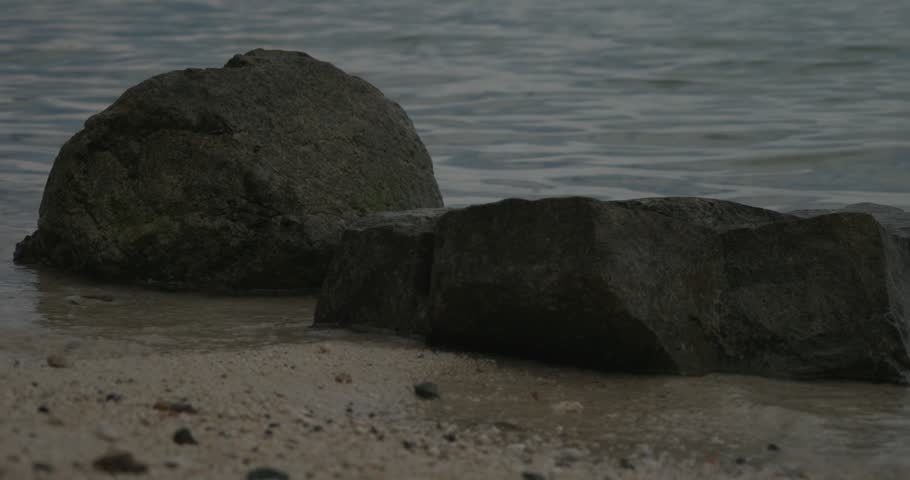 close up of 2 rocks on the shore