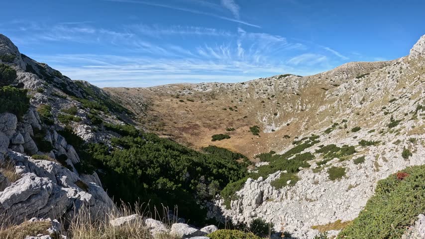 Mature hiker hiking Dinara Mountain in Croatia