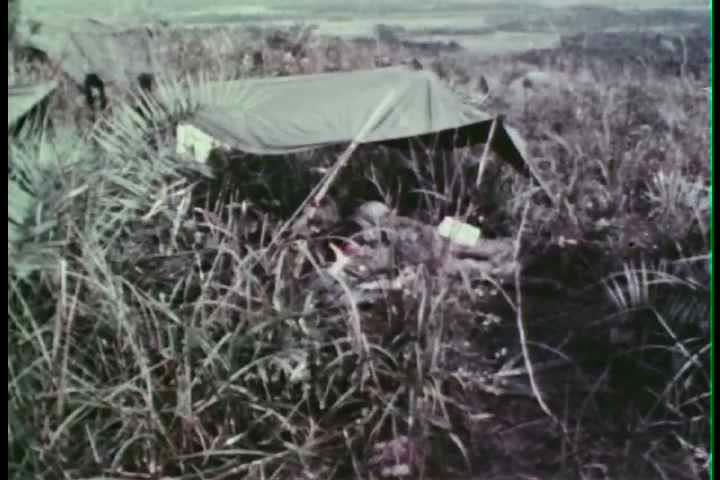 1960s - Marines march through Vietnamese jungles and avoid booby traps during the 1960s