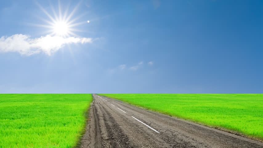 road across a fields time lapse scene